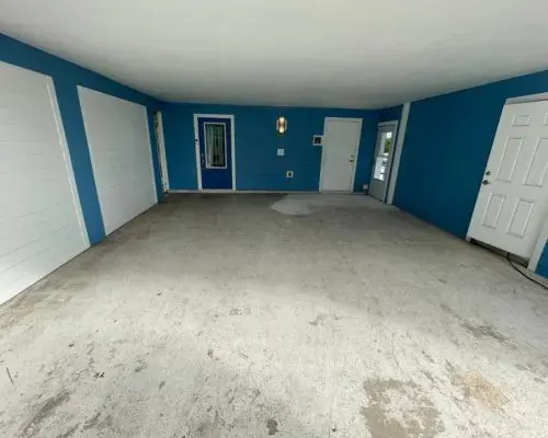 Stained garage slab in Brevard County before resurfacing