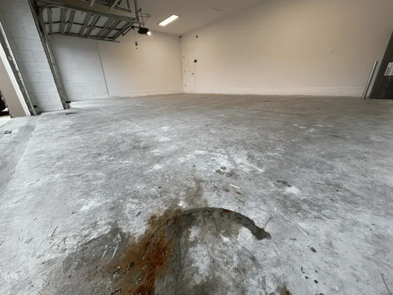 Bare concrete garage floor in Palm Bay before the flake coating was installed